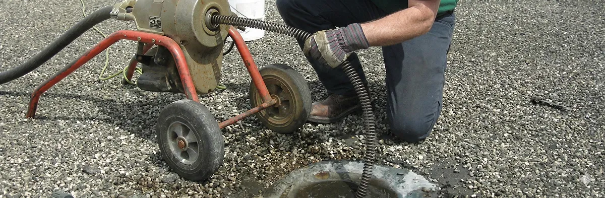 sewer rodding technician actively removing blockages from a sewer line in Grand Rapids, MI